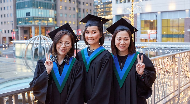 Three female VCC graduates pose for a photo