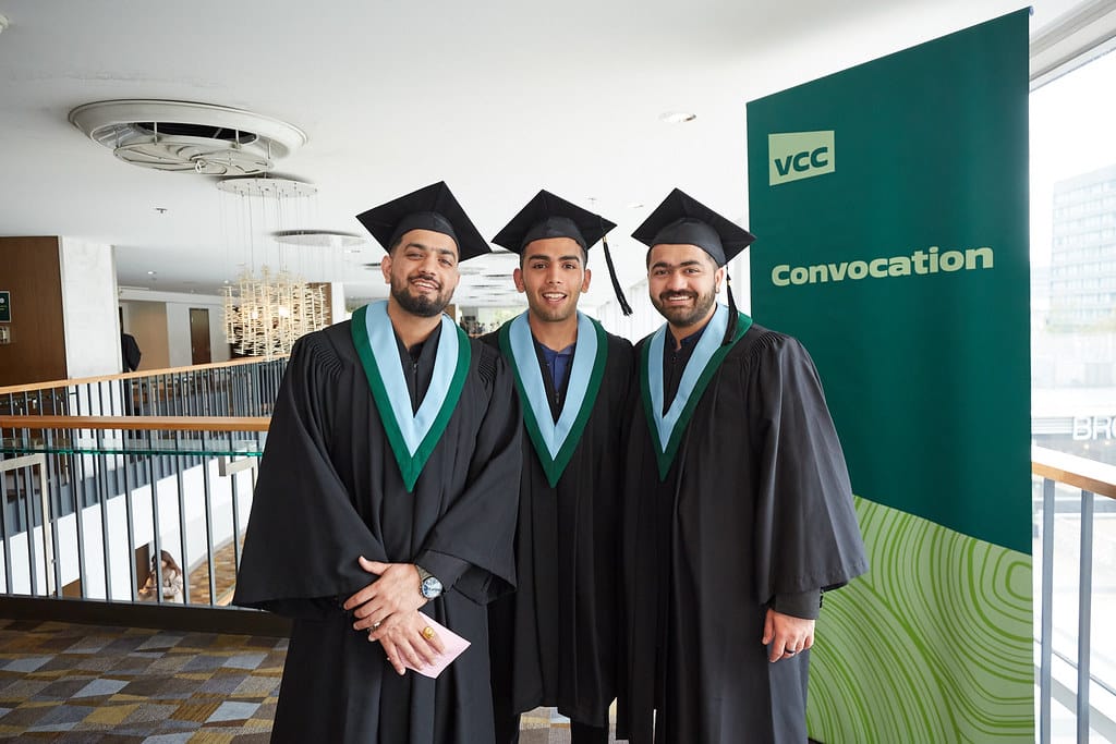 Three VCC graduates pose for a photo