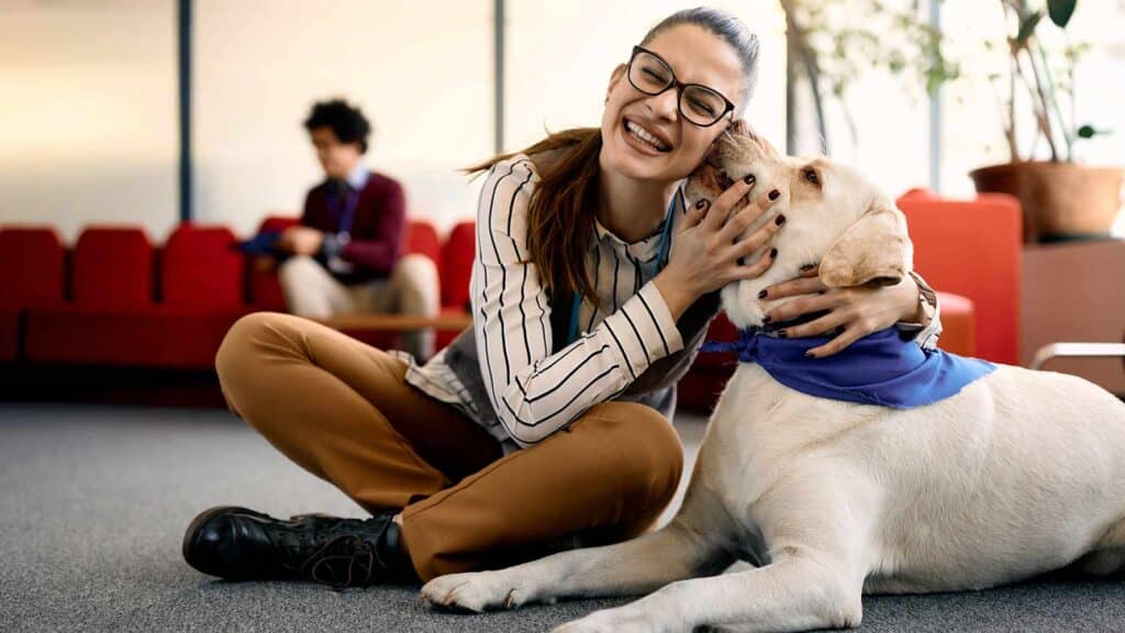 Happy student hugging a therapy dog