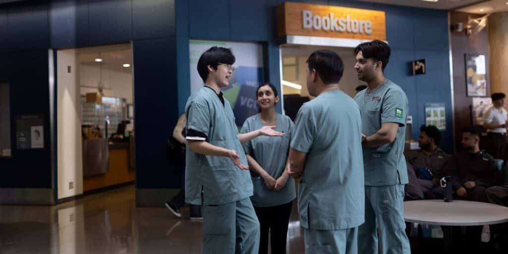 VCC nursing students chatting among themselves in front of a bookstore.