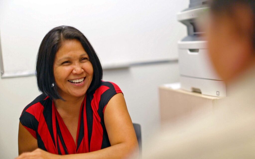 Indigenous advisor smilling at a student she is advising