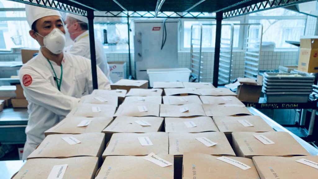 Student chefs packing charity boxed lunches