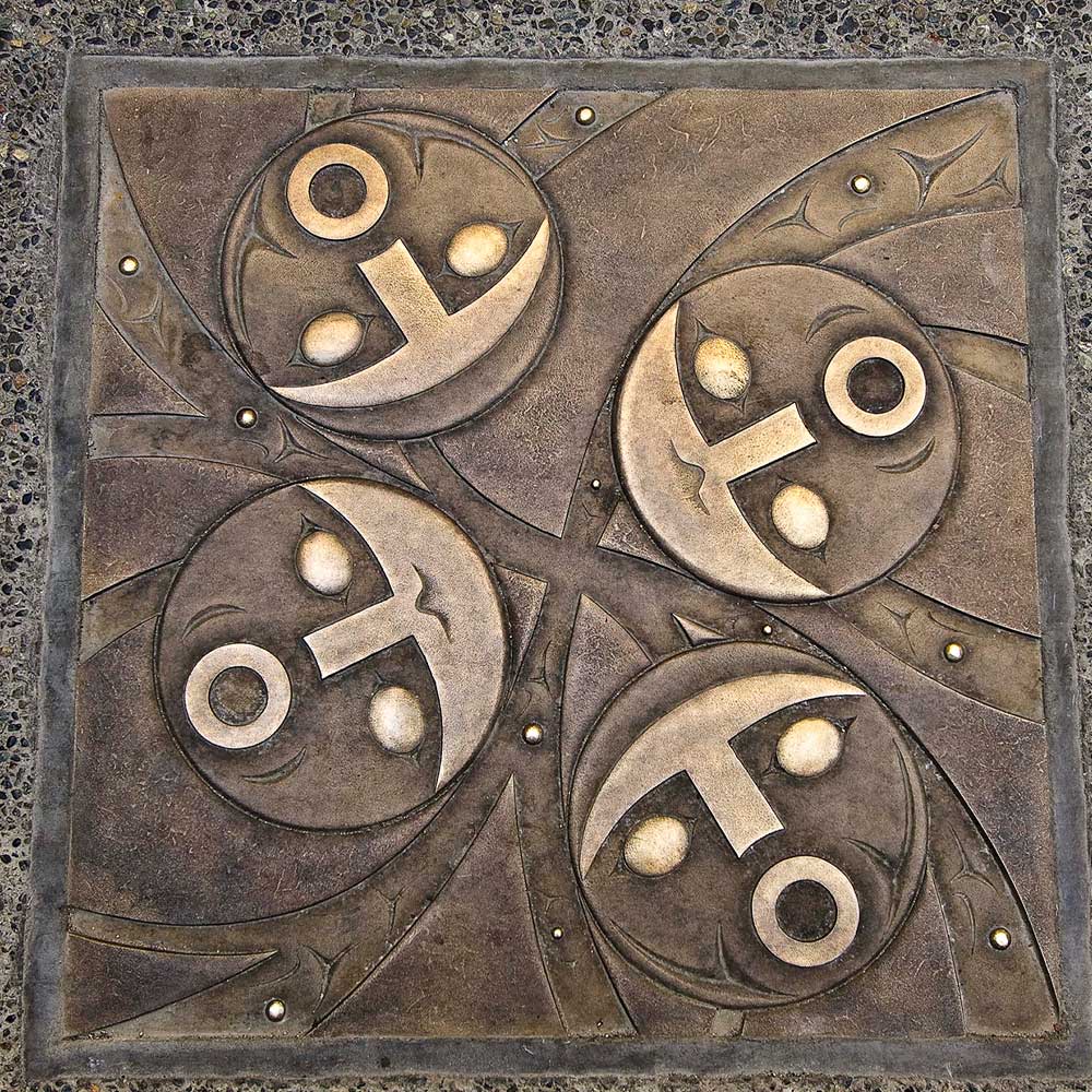 indigenous art bronzed of four faces