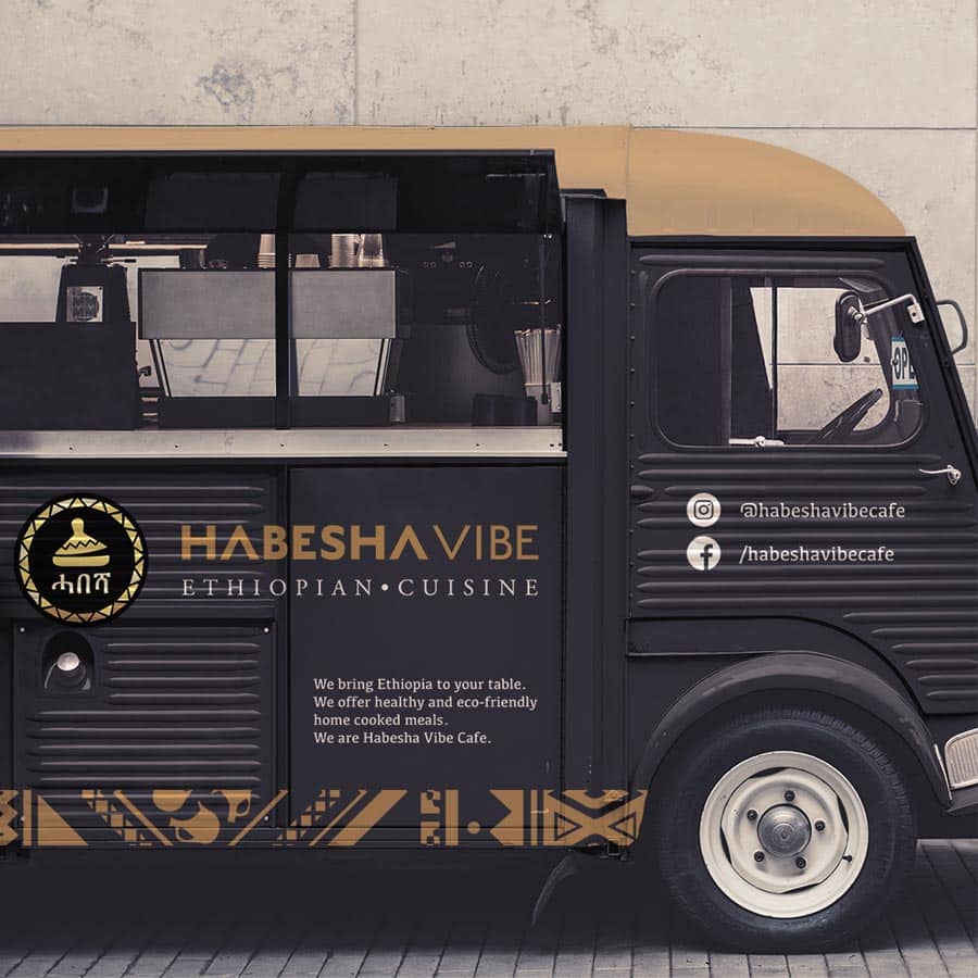 A professional vehicle wrap for an Ethiopian cuisine food truck, featuring gold accents and cultural patterns on a black background.