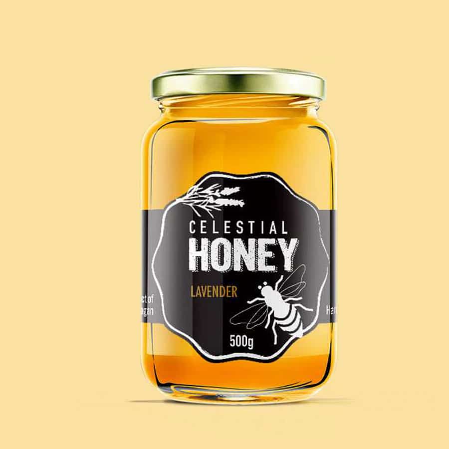 A product mockup of a glass honey jar with a black and white label featuring a lavender sprig and a bee illustration.