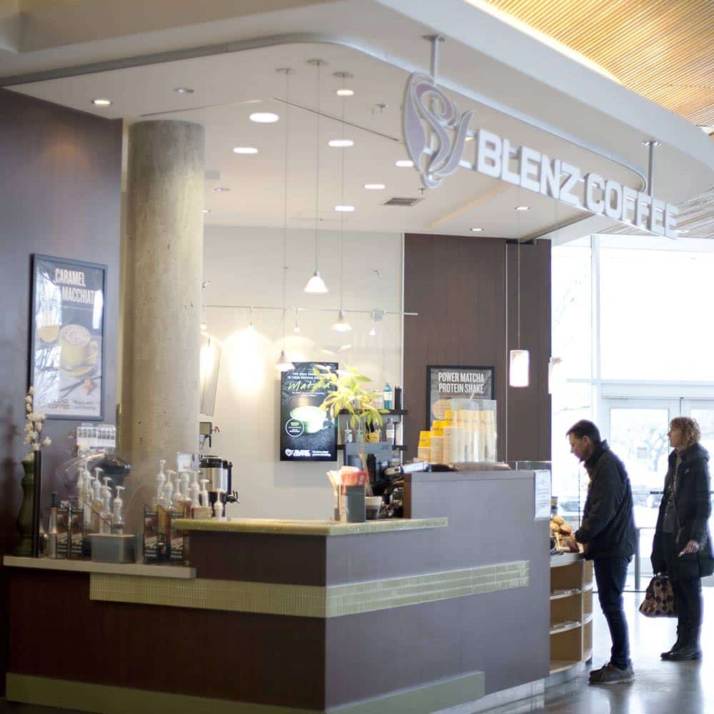 A bright, modern Blenz Coffee kiosk on campus offering a variety of beverages and snacks to students.