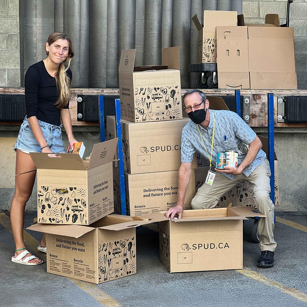People packing boxes for Spud.ca, an online grocery delivery service